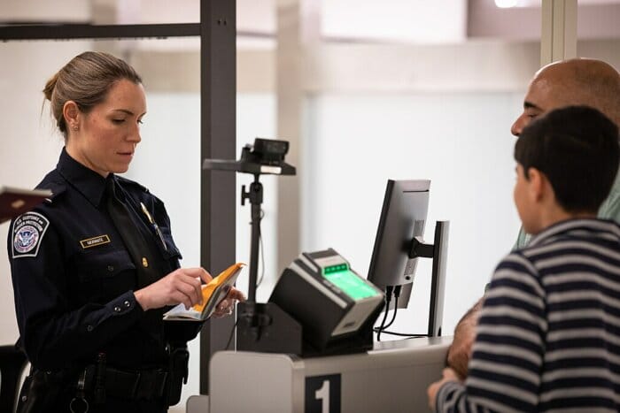 A CBP officer screens travelers at Miami International Airport.