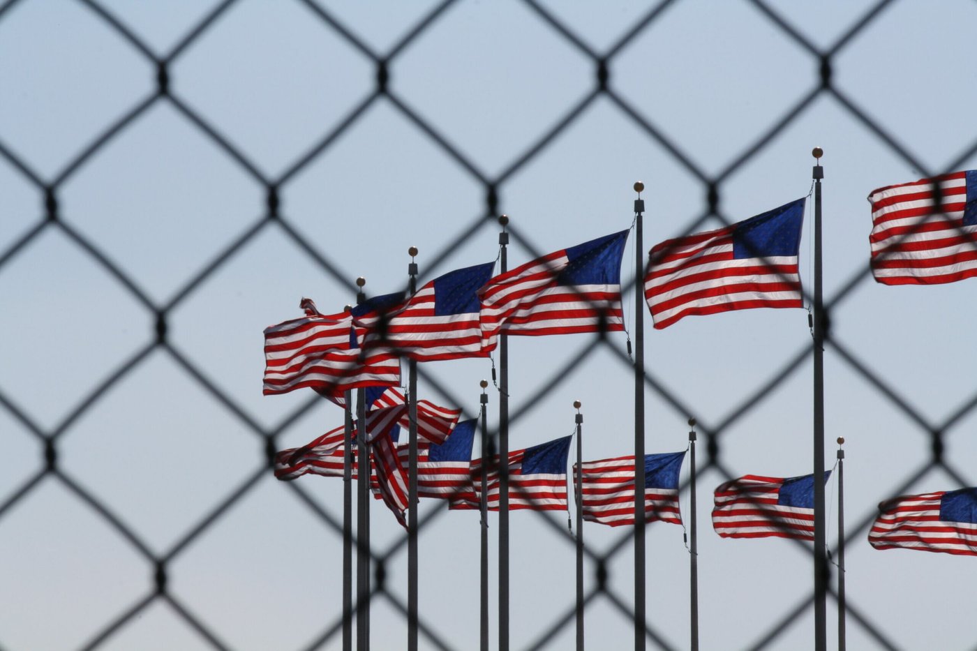 American flags behind a fence