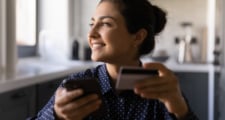An immigrant holding a credit card.